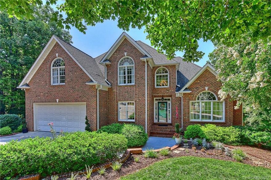 Wow! Hard to find updated 6 BR, 4.5 BTH 2 story with basement on almost 1 acre lot backing to the end of a cove in the Anchorage subdivision in Tega Cay.  Need garage space? Can do! Four car garage with more storage and workshop area. Great stay-cation home with a heated pool, spa, volleyball court.   Model perfect home has been remodeled and offers a master BR on the  main level. Very open floor plan. Great outdoor living with oversized double decks. Unique opportunity! No water access.