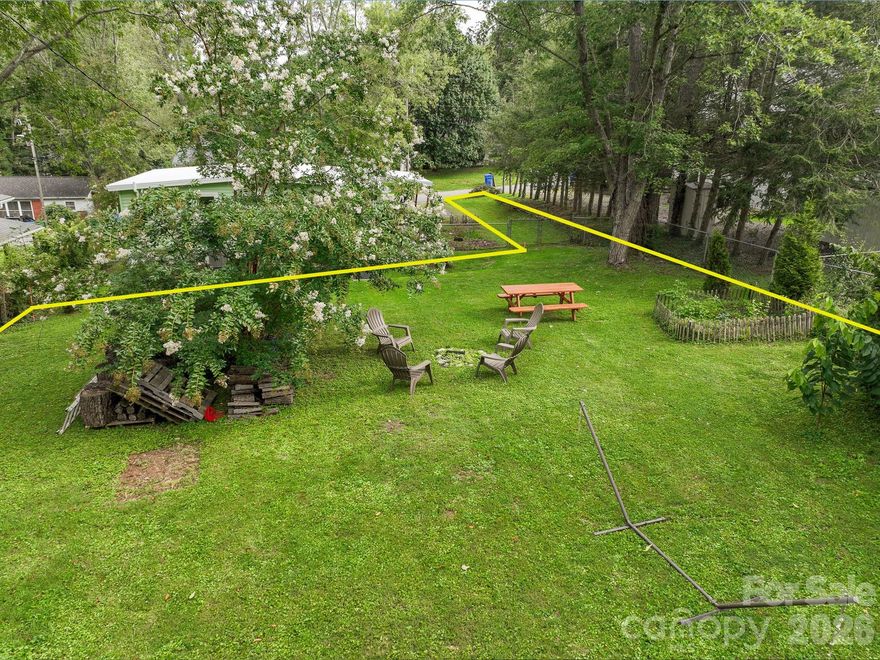 Flat, cleared, and ready to build — this rare RS-8 flag lot sits just minutes from the heart of West Asheville's Haywood Road corridor, with its beloved restaurants, breweries, galleries, and Carrier Park, yet feels tucked away on a quiet, no-outlet street. City water availability has been confirmed, and the lot's location makes tying into additional utilities straightforward. The lot is partially fenced and the surrounding neighborhood offers the kind of mature, established character that's hard to find this close to everything West Asheville has to offer. Don't miss a chance to put down roots in one of Asheville's most vibrant communities.