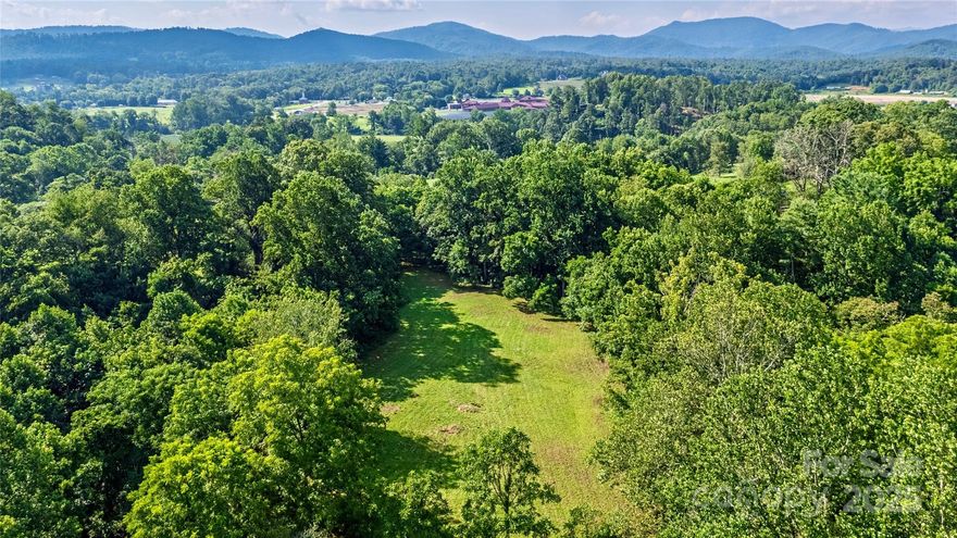 Over five and a half acres of pristine land awaits in the coveted Cane Creek area of Fairview! This OU zoned property offers the perfect canvas for your mountain dream. Natural features include winter mountain views, a live spring and creek flowing through the property, gently sloped terrain ideal for building, and an already cleared area ready for your vision. Whether you are building a private mountain retreat, homestead, small farm, or multi-generational family compound, the open-use zoning provides maximum flexibility. The property's natural water sources and varied topography create distinct microclimates perfect for gardens, orchards, or naturalized landscaping. Located in desirable Cane Creek, you'll enjoy the peaceful rural atmosphere while remaining conveniently accessible to local amenities of Fairview and Asheville. A rare opportunity to own a substantial piece of WNC's beautiful landscape. Property has been surveyed, full house plans available, and septic permit approved!
