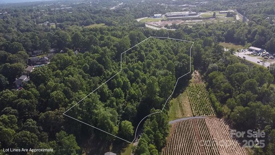 At the edge of Morganton’s Downtown District, and right next to South Forest Subdivision, is a 7.47 Buildable Lot with City Water/Sewer/Electric and Fiber Internet. This rare find is tucked away at the end of the Knollwood Dr. culdesac. This creek-front property is a beautiful wooded sloping lot that feels like your own mountainside. The parcel neighbors a tree and hedge nursery, adding to the peaceful landscape. It’s rare to find this much land just a hop, skip and a jump from the bustle of downtown. The parcel is located only three minutes from the delicious Waterbean Coffee and convenient to a plethora of local businesses & shopping. A preliminary road has been graded through the property for easy access. This gem is a perfect choice for a Private Estate, Log Home build, or new Sub-Development. Just 25 minutes to Lake James, one hour to Asheville, and a little over an hour to Charlotte! Contact listing agent with any questions.