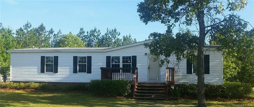 REDUCED:  Spacious manufactured home located in a rural subdivision on large 1.5 acre parcel, close to Hwy #151 for quick access to area amenities. Make this house a home with your own update/renovation ideas. It features an open living/dining adjacent to large kitchen with island and plenty of cabinets. The split floor plan affords privacy to the master bedroom and bathroom. The other two bedrooms have easy access to the full hall bathroom.  Detached storage, front deck and rear covered porch.
