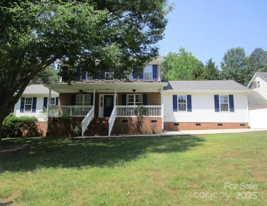 Welcome Home! Well maintained, move in ready home on corner lot with views of Lake Norman. Open main floor plan with 2 primary bedrooms with en-suites and a kitchenette in second primary. Main floor eat in kitchen with island and connected dining area. Perfect for entertaining the main floor is complete with both family room and living room or for use as an in law suite. Upstairs is an additional bathroom and three rooms with closets that are currently used as bed/bonus rooms and an office. Enjoy the summer on the covered front porch relaxing or grilling on the back deck. Large corner lot with plenty of room for games or just relaxing by the fire pit. Plenty of room for storage in the two sheds/ wired workshop.