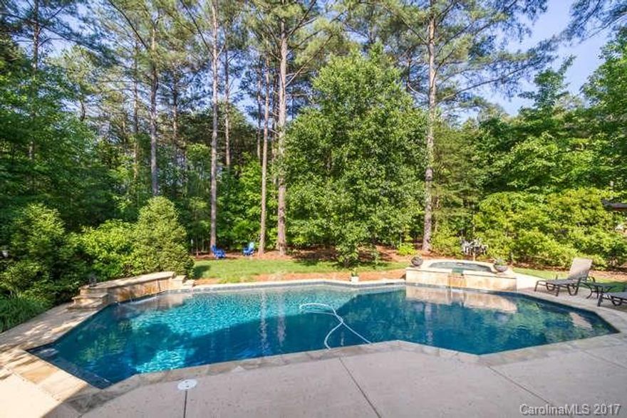 Southern Charmer w/rocking chair front porch and backyard oasis!**Custom salt water gunite pool/hot tub with stone hardscape and waterfall feature.Open floor plan with soaring two story great room and wall of windows.Spacious custom gourmet kitchen with fantastic counter bar and breakfast nook.Hardwood floors throughout first floor.Open living/dining for ease of entertaining.Backyard BBq's on covered porch and deck overlooking private, lush landscaped, fenced yard.