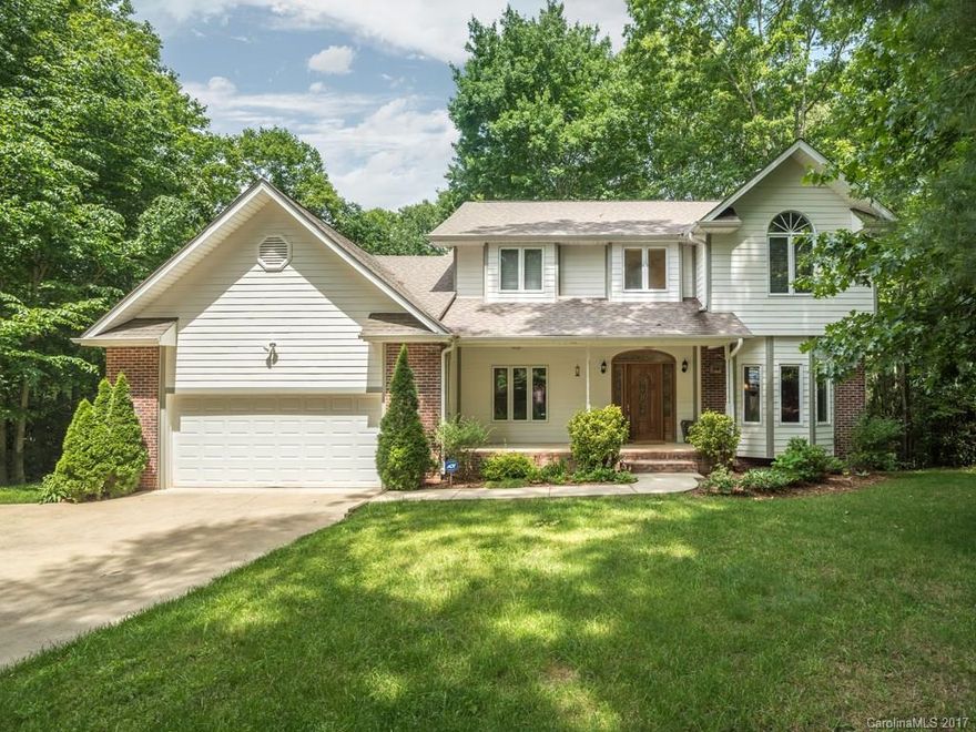 Space for everyone inside and out this private and convenient home located on a peaceful, wooded lot.  Living room with fireplace opens to tranquil outdoor spaces.  Enjoy the multi-level decks, hardwood floors, rocking chair front porch and eat in kitchen. Fantastic room for expansion in the full unfinished lower level, plumbed for a third bath.  Welcome Home!