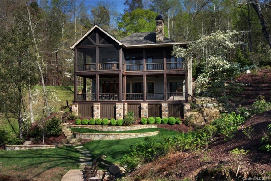 Searching for the ultimate lake home? Well, look no further. Built on the best fishing cove on the lake, this meticulously crafted residence enjoys majestic mountain views from two spacious covered decks, Master & Guest suite on Main, beautiful oak hardwood floors, Isokern fireplaces, low-E windows, 8 ft. raised panel doors, plantation shutters. Kitchen features Dacor six burner gas range, SS appliances, textured granite counters. The double bay boathouse has a sundeck and covered deck space.