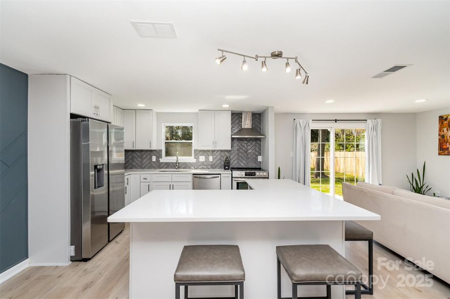 Welcome to 9105 Touchstone Ln! This nicely updated ranch home offers true move-in readiness with renovations completed in 2022, including the roof, HVAC, water heater, floors, kitchen, and baths. Enjoy entertaining friends and family in the  sleek kitchen with an oversized island and cozy wood burning fireplace in this open floor plan. The home features a large fourth bedroom or bonus room for added living space and a recently cleared, fenced, level backyard perfect for recreation, or future pool on its ample sized lot. Conveniently located near I-485 and a twenty-minute drive to the vibrant shops and restaurants of NoDa and Plaza Midwood, all with no HOA. Come see this wonderful home today! ***Ask about lender credit for rate buy down up to $4,000.***