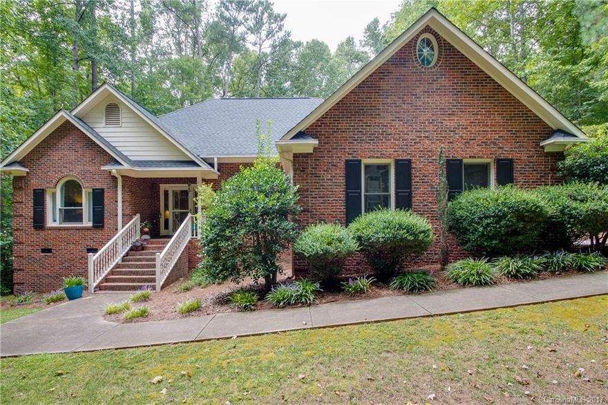 Hard to find Full brick home on quiet street near the heart of downtown Waxhaw. 3 bedroom ranch with split bedroom plan. Granite counter tops in kitchen. Hardwood flooring on most of main. Vaulted ceiling in great room with stone fireplace. Large Owners bedroom with walk in closets. Dual vanities in owner's bath. Dining room could be office with pocket doors. Screened porch off over sized deck overlooking partially wooded private lot. Fire Pit. Roof 2014