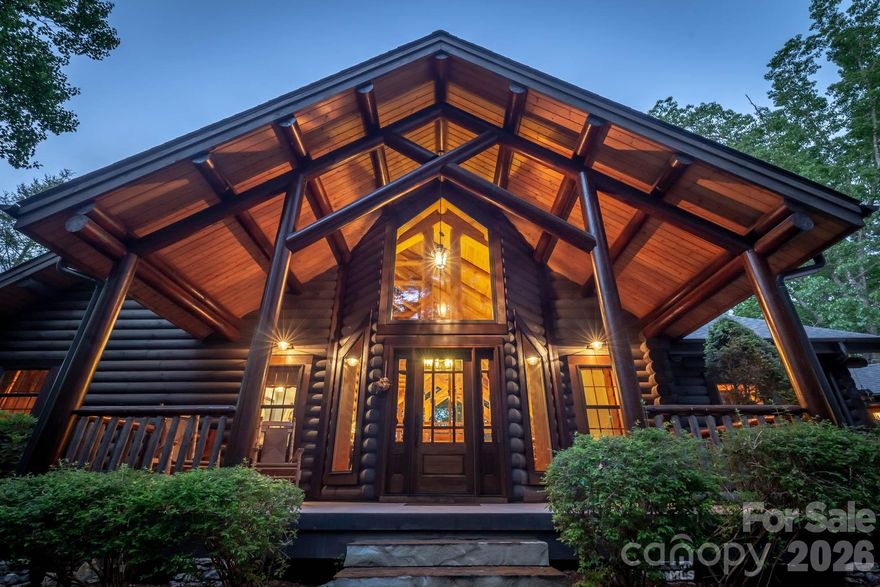 Listen to the rushing waters of the stream and waterfall that encircle the house as you enter this magnificent log home. The soaring ceiling & expansive windows capture views of the surrounding trees.  Brazilian walnut flooring & the floor to ceiling stone wood burning fireplace are the centerpieces of this great room. Open kitchen & dining area provide ample entertaining space. Spend cozy evenings on the screened porch with a fire or on the deck overlooking Lake James. Main level primary suite with gas fireplace & ensuite bath with large tiled shower and jet tub.  Lower level has 2nd primary suite with gas fireplace, a bunk room and a 4th bedroom both share access to a hall bath with claw foot tub.  A second kitchen & stone fireplace in the family room provide a cozy entertainment area with pool table & TV.  Lower level patio with stamped concrete features outdoor shower, hot tub and adds a great location for outdoor dining. Enjoy a short walk down the stone stairway to the gazebo in the woods or continue on to the lake where you'll find an expansive covered gazebo & floating dock in the quiet deep water cove. Detached 2 car oversized garage has space for cars and boats. Many updates including composite decking on front, rear and breezeway decks as well as new gazebo rails, new floating dock and refurbished waterfall feature.   Located on 5.73 acres, this family compound at Lake James is the place you'll want to choose to make your lake life memories.  Black Forest is a gated community about 15 minutes from Marion and features a community center, lake and river camp amenity areas with picnic pavilions, fire pits, lake access and miles of hiking trails throughout the community. Offered turnkey with few exclusions.