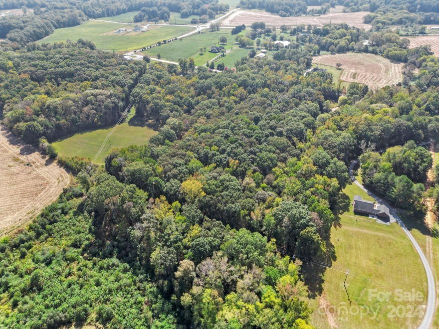 *PROPERTY WAS SOLD AS 4.55 ACRES. ADDITIONAL ACREAGE WAS ADDED BY A SPLIT ADJACENT PARCEL.
Discover the ultimate canvas for your vision of luxury living in the heart of Wesley Chapel, North Carolina. This remarkable 3+ acre parcel offers an exceptional opportunity for those seeking a beautiful private estate free from the restrictions of an HOA. This parcel is the front parcel of a 3 parcel piece of land, totaling 10 acres. Located in the highly desirable Union County, known for its excellent schools, low taxes, and a strong sense of community, this opportunity offers easy access to the village of Wesley Chapel, where you'll find local shops, restaurants, and a friendly atmosphere. This property combines serenity and convenience, allowing you to build the home of your dreams, complete with all the amenities and space you desire! Bring your own builder or partner with Faithwood Construction to build your dream home!