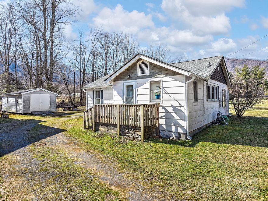 With this 3BD/1BA Farmhouse situated on 1.538 Acres, discover an extraordinary & rare opportunity in the heart of Maggie Valley along pristine Soco Creek a Class B Trout Stream, perfect for fishing! This 3BD/1BA original family farmhouse has a shared well and septic, an unfinished garage apartment w/roughed-in electric & plumbing, a workshop, and shed.  This versatile property is an ideal full-time, part time or rental! The property is located in R-3 High Density Zoning of Maggie Valley. Sewer is already on the property/easy to connect to City Water! Alot of room for expansion. Zoning allows for 10 multiunit per acre or 5 single family per acre. Perfect location for small fishing cabin rentals or just call the farmhouse your mountain home. Located just minutes away from Cataloochee Ski Area, Blue Ridge Parkway, Harrah's Cherokee Casino, & Asheville, it presents an investor's paradise in a welcoming community. Take advantage of the proximity to restaurants & a brewery & embrace the endless possibilities this Maggie Valley gem offers.