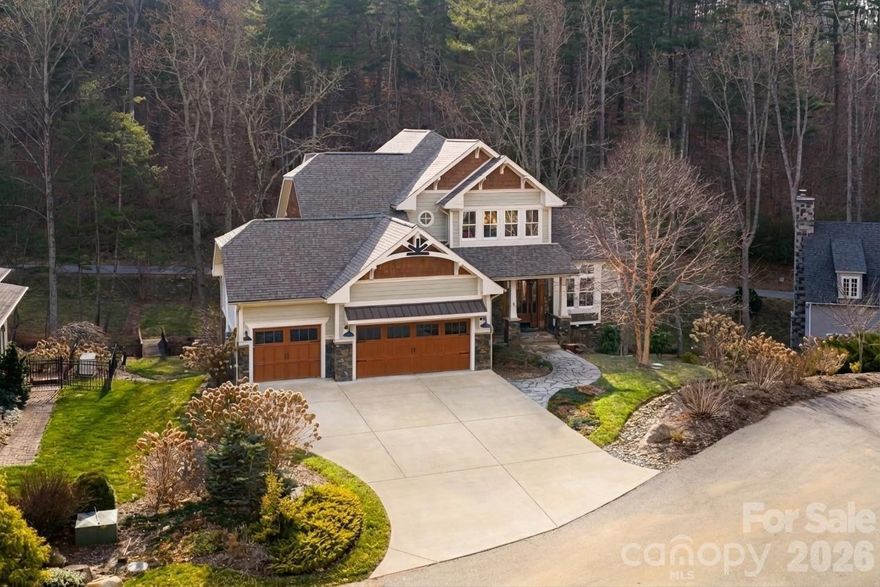 Experience the pinnacle of Asheville luxury in this exquisite custom home, perfectly situated within the prestigious gated community of Town Mountain Preserve. Designed for the discerning homeowner who seeks a harmonious blend of privacy, nature, and proximity, this residence offers a secluded sanctuary just minutes from the vibrant culture of downtown and the premier conveniences of North Asheville. Rarely does a mountain property offer such effortless connectivity; this community features dual-gated access points that provide a strategic advantage for daily living. Use the southern entrance for immediate access to Downtown Asheville’s world-class culinary scene, art galleries, and boutiques, or utilize the northern gate to connect seamlessly to North Asheville’s upscale shopping, organic grocers, and excellent dining. Tucked away in a quiet, wooded environment, yet never more than a short drive from the city’s heart. This home is a masterclass in architectural balance, merging contemporary elegance with timeless mountain charm through custom high-end finishes that elevate the living experience throughout. The thoughtful floor plan is designed for both comfort and entertaining inside and out, featuring a spacious main-level primary suite and oversized garage for effortless accessibility. The upper level boasts a second primary suite and a well-appointed guest room, while the terrace level provides a private fourth bedroom and versatile living space. While the kitchen offers a tasteful and functional heart to the home, a true showstopper is the dedicated theater room perfect for hosting unforgettable evenings.This mountain property features a private park-like setting complete with a custom firepit for gathering under the stars. This residence caters perfectly to those looking for a permanent "forever home" or those searching for a high-end mountain escape, offering a lifestyle defined by quality, tranquility, and the natural beauty of Western North Carolina. From the sophisticated security of a gated woodland retreat to the unparalleled privacy of its quiet lot, this home represents the very best of the Blue Ridge lifestyle, ensuring you are close to the action yet worlds away from the noise.