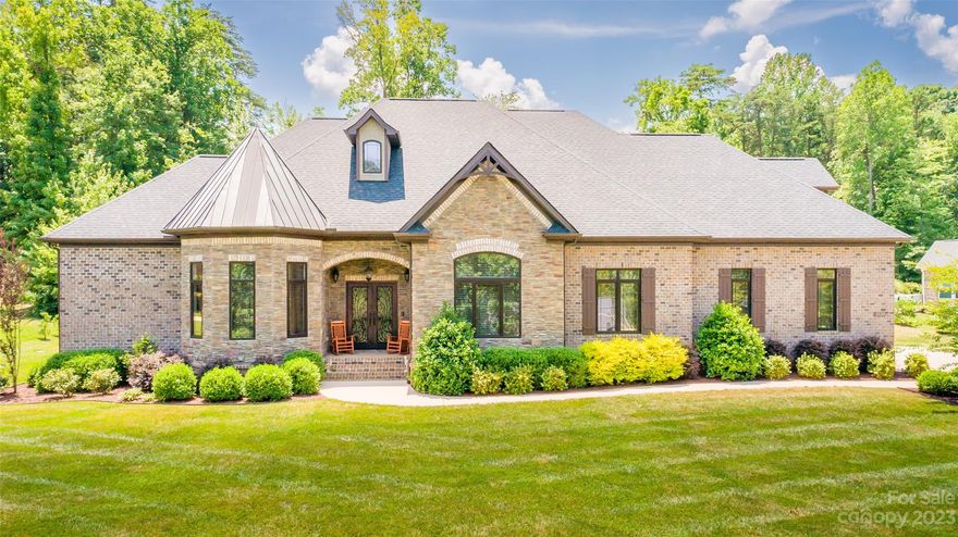 Looking for a 4 Bedroom custom ranch with exquisite craftsmanship, style & detail in a waterfront community on Lake Norman? This home will knock your socks off with it's exceptional coffered ceilings, exquisite Gourmet Kitchen with a huge center island that chefs will love. All bedrooms have an ensuite private bathroom & large closets with lots of built-in shelving. Upstairs offers a Bonus Room with great flexibility of use plus a huge walk-in attic. Guests will be impressed upon entering the gracious foyer with large double  decorative wrought iron doors, tall ceilings & open floor plan. Looking for low maintenance? This home features a brick & stone exterior with gutter guards. Got pets? Inside boast beautiful wood grained tile in most of the common areas for easy wear and tear. Relaxation is a snap in the huge screen porch that looks out to your private fenced backyard with room for a pool. Conveniently located with a quick commute to Charlotte & airport, shopping & restaurants.