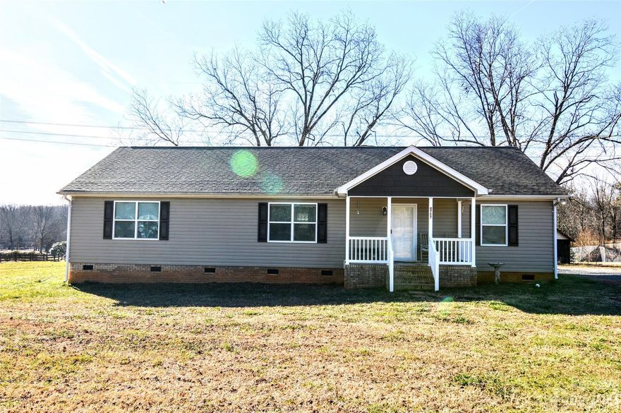 A Roomy Vinyl Ranch Home Located on a 1.39 Acre Lot!  Tons of Open Space on this level lot!   
 Nice Long Driveway with plenty of parking space.  Covered Front Porch!  Large Living Room for Lots of relaxing.  A Split Bedroom Floor Plan.  The home includes 3 Bedroom and 2 Full Baths.  Master Bedroom has Spacious Walk in Closet.  1680 Square Feet. Huge Modern Kitchen with Kitchen Island and Breakfast Bar and Black Appliances with Built in Microwave.     Large Dining Area for Family Dinners with Can Lights.  Luxury Vinyl Plank Flooring and Carpet throughout.  Roomy Laundry Room.   Nice Deck Overlooking the Backyard.  Older Shed included on the Property.
