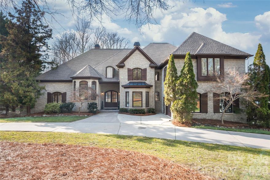 Rare opportunity to own a custom-built Arriscraft stone and full brick estate set on 1.26 private wooded acres in an exclusive NO HOA enclave just off Providence Road, inside I-485. Offering nearly 7,700 square feet across three finished levels, this exceptional home features 6 bedrooms, 5 full baths, 2 half baths, and a 3-car garage, providing generous space for everyday living, entertaining, and multigenerational flexibility in a setting that is increasingly rare to find in South Charlotte.

Designed for those who value privacy, land, location, and enduring construction, this estate also offers a unique opportunity to thoughtfully update interior finishes and tailor the home to your own vision while preserving its remarkable craftsmanship and scale.

Inside, the home showcases wide-plank Brazilian walnut hardwood floors, custom millwork, and two impressive stone fireplaces that anchor the main living spaces. Expansive room sizes and a thoughtful layout create a seamless flow ideal for both daily living and large gatherings. The CHEF'S KITCHEN features a five-burner cooktop, abundant cabinetry, and generous counter space, opening to the main living and dining areas for effortless entertaining.
The MAIN-LEVEL PRIMARY SUITE offers a peaceful private retreat with direct access to the balcony, overlooking the pool and serene wooded backyard.

Step outside to your PRIVATE BACKYARD oasis, complete with a GUNITE POOL, SCREENED PATIO, and beautifully wooded grounds backing to natural land, ensuring permanent privacy behind the property.
Upstairs, four spacious bedrooms (three ensuite) and additional flexible living areas provide comfort and privacy for family and guests. Two additional rooms offer ideal space for a home office, library, studio, playroom, or hobby space.

The fully finished walk-out lower level expands the living space even further, offering ideal accommodations for multigenerational living, an in-law or au pair suite, as well as a recreation or media room with space for billiards, fitness, or additional flex areas. With direct access to the pool and outdoor spaces, the lower level functions almost as a private residence within the home.
Major system updates include ROOF (2019), HVAC Systems (2021), and WATER HEATER (2025), providing valuable peace of mind.

Located in the TOP-RATED Providence High SCHOOL DISTRICT and near several prestigious private schools, the home offers unmatched convenience—less than a mile to The Arboretum and just minutes to I-485, SouthPark, Uptown Charlotte, and major business corridors.

Land that cannot be recreated. Privacy that cannot be rezoned. An estate built to last.
This is a rare opportunity to shape a true South Charlotte legacy property into your own.
SCHEDULE YOUR SHOWING TODAY.