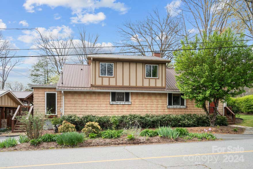 Meticulously maintained home located just 4 blocks from the center of downtown Black Mountain.  Unwind and enjoy family and friends in the fenced in private back yard.  The covered "party" gazebo with power can accomodate a hot tub if you'd like, or just relax and cozy up to the fireplace. Plenty of sitting room in gazebo and on the large deck. This is the perfect home for entertaining. The interior is stunning - a large keeping room, with stone fireplace is located adjacent to the kitchen and leads out to the sunroom.  Beautiful hardwood floors throughout home, open and airy feel with the large windows. The Primary Bedroom suite on the upper level is a perfect place to have that private quiet time.  Currently used as Airbnb with excellent rental history.  Owner Broker.