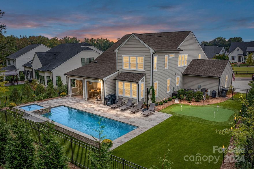 Custom, Stunning & Pristine, 5 Bedroom, 5.5 Bath Home with 3 Car Garage & Amazing Outdoor Living with Salt Water Pool/Spa, Putting Green & Covered Entertainment Area with Stone Fireplace, surrounded by fully Fenced Back Yard with tons of mature trees & plenty of lush landscaping, in desirable community! Beautifully appointed throughout with so much attention to detail! Chef's Dream Kitchen offers quartz counters, massive center island with seating/storage, gas range, custom hood system, stainless steel appliances, custom tile back splash, custom lighting including under cabinet & recessed, beautiful cabinetry & pantry! Spacious Dining Area! Office with French Doors & detailed millwork! Spacious, Convenient 1st Floor Primary Suite with huge walk in closet & luxury Bath! Primary Bath features dual, marble vanity, large, walk in tiled shower & tile floors! Guest Suite on main with ensuite bath! 3 Additional Bedrooms on upper level (all ensuites)! Huge Loft/Bonus area on upper level!