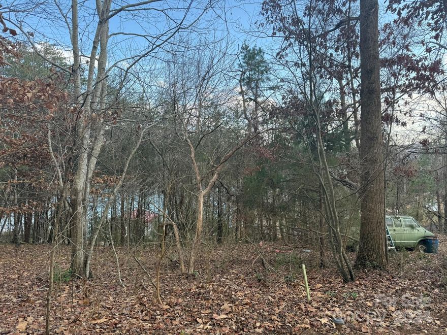 What a beautiful location! Build your dream home on over an acre next to Lake Hickory in Taylorsville!  Trees can be removed to reveal mile-long view, overlooking the lake and Crappie Cove.  The only traffic you hear on this dead-end road are the boats going by.  CASH or USDA LAND LOANS ONLY!  Visit Sandbar Marina up the road, or take a dip in the lake at the new swim spot nearby (Wittenburg Access Area Swim Beach).  The manufactured home on the property is in need of major repairs and will not be deemed livable, according to multiple Lenders.  No HOA!  County water is available for hookup, per Seller.