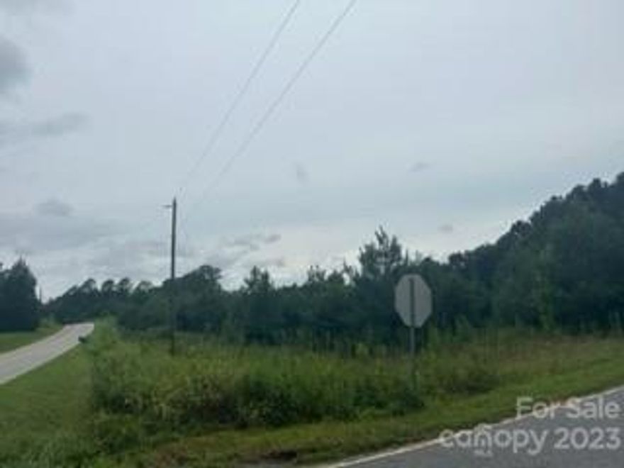 Great location for your home. Level 3.6 acres with some trees. Septic required. Public water available. There is an old singlewide mobile home on the property that will stay with no value. There is a railroad track at the rear of the property carrying materials for Duke Energy.