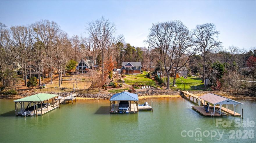 UNDER APPRAISAL – TURNKEY WATERFRONT WITH DOCK + SUNSET VIEWS ON LAKE NORMAN
Exceptional opportunity to secure a fully furnished, move-in ready waterfront home positioned on open water with a private dock and sunset-facing views—now offered below appraised value.
Built in 2018 and significantly upgraded beyond builder standards, this property delivers the rare combination of condition, location, and immediate usability that today’s buyers are searching for.
Vaulted ceilings and expansive windows frame wide lake views and fill the open-concept living space with natural light. The kitchen is designed for both everyday living and entertaining, featuring River Marble flooring, upgraded granite, and premium appliances including a Bosch dual-fuel range, warming drawer, Bosch dishwasher, and LG refrigerator. The oversized peninsula creates a seamless flow into the dining and living areas, anchored by a gas fireplace and direct access to a sunroom overlooking the water.
Hickory hardwoods extend throughout the main living areas and bedrooms. The primary suite captures lake views and offers functional convenience with direct access to the laundry room. Interior finishes include crown molding, custom window treatments, and well-appointed baths with a soaking tub.
Outdoor living is where this property separates itself. A maintenance-free deck with a fully equipped outdoor kitchen and electric awning overlooks the lake, while professionally designed landscaping—with over 100 tons of river rock—creates a polished, low-maintenance setting. A lighted pathway leads to a lakeside patio with fire pit and down to the private dock.
The covered dock includes an 8,000 lb boat lift, sun pad, and dual jet ski ports—ideal for immediate lake use or short-term rental income potential.
Additional features include a whole-home generator, 10x12 storage building, and walk-in basement with partially finished bath offering expansion potential. No HOA.
Offered fully furnished for a true turnkey experience.
Ideal as a full-time residence, second home, or investment property with strong rental appeal.
Opportunities like this—priced below appraisal, fully furnished, and ready for immediate enjoyment—are limited on Lake Norman. Schedule your showing today.