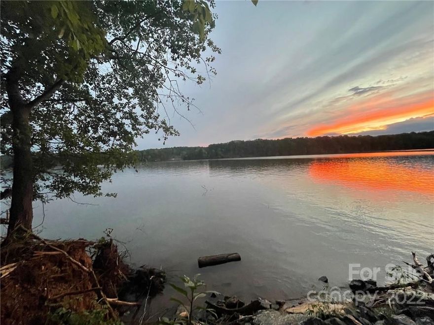 Gorgeous waterfront lot in gated Harbor Watch community. Tucked away from the hustle and bustle, this beautiful neighborhood and treed lot offers main channel and island views, and sunsets for days! Build your dream home, bring your own builder. Pier permit is updated and ready to go in attachments! Lot perked for 4 bdrm in 2006. See expired septic permit in attachments. This lot would make the perfect year-round or seasonal home site. Community boat dock and ramp to left of this lot. Neighborhood amenities include a marina and boat launch, picnic areas, two private islands for residents and their guest to enjoy, secure boat storage, and two stocked inland ponds (catch and release only). HOA docs attached. Restrictive covenants and architectural review apply to all home sites.