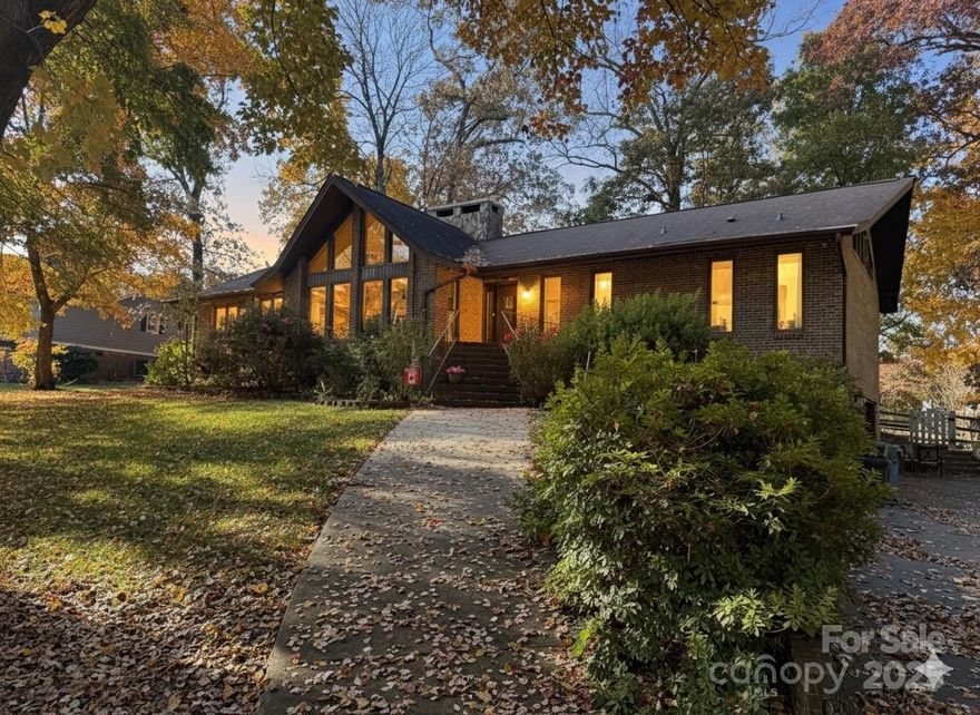 Hitting the market January 5th!

This 4-bedroom, 2-bath home in Mint Hill is situated on the 2nd hole of Pine Lake Country Club and offers a distinctive layout with the main living area located entirely on one level once inside.

The home features vaulted, extremely high ceilings and floor-to-ceiling windows at both the front and rear, filling the space with natural light. A large stone fireplace serves as a striking focal point, thoughtfully dividing the great room and dining area. Hardwood flooring runs through the kitchen, great room, and dining room, creating a cohesive flow throughout the main living spaces.

The kitchen and both bathrooms were fully gutted and updated approximately seven years ago. The floor plan includes a dedicated laundry room with a wash tub and four bedrooms, with no carpet anywhere in the home. Both end bedrooms offer direct access to the rear deck, which spans the full length of the back of the house.

Conveniently located just minutes from I-485, shopping, dining, and local amenities, this property combines a desirable setting with easy access to everything Mint Hill has to offer.