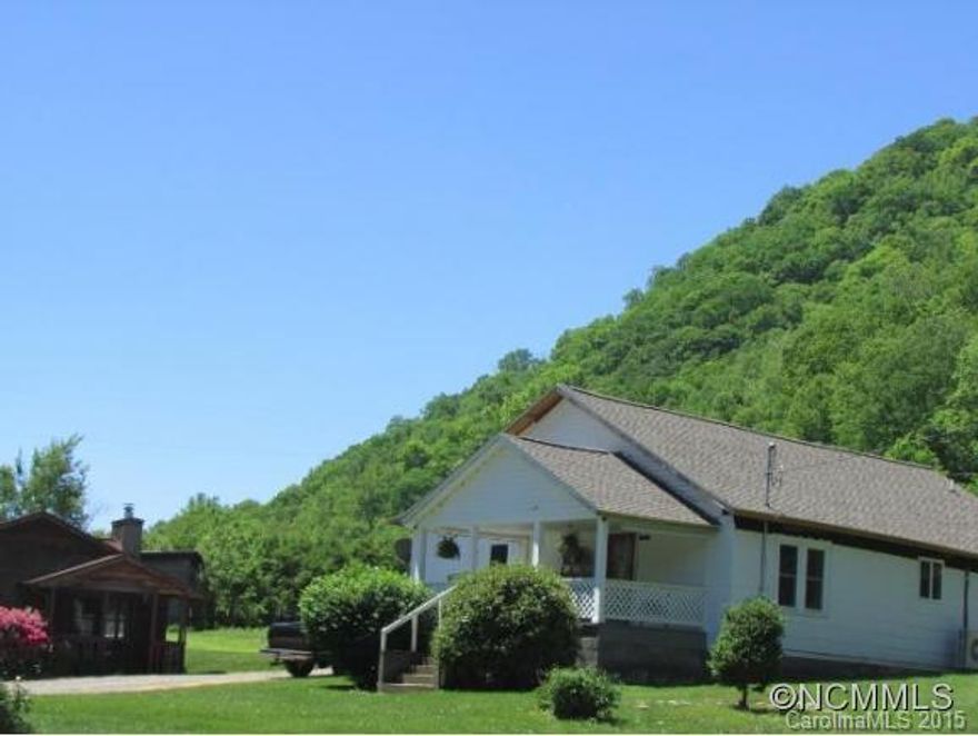 FRONTAGE ON THE CANE RIVER PLUS TWO Homes situated on 5.3 acres. GREAT MINI FARM!  in one and rent the other.Land is gently sloping, open pasture land with approx.1-2 acres on the river. Farmhouse consists of 2 bds, 1.5 baths, Great room w/wood stove, formal dining and front & side covered porch. Mobile w/addition consists of two bds, bath, utility room, open living area, dining & kitchen. Covered side porch & front deck; w/approx. 1456 sq. ft.