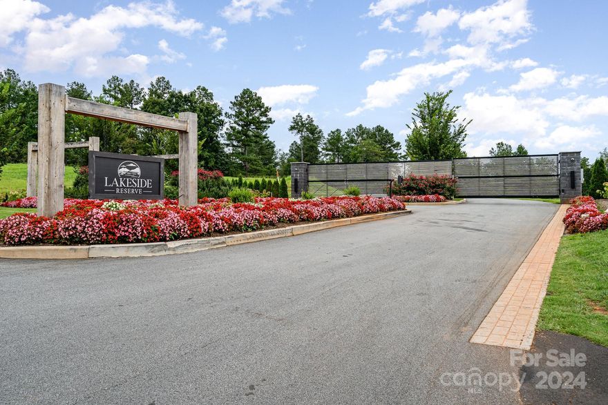 Welcome to Lakeside Reserve, where your dream home awaits. Lot 27 is a 2.5-acre wooded parcel, offering a serene backdrop with a charming creek at its rear, perfect for designing your ideal residence. This exclusive gated community boasts upscale amenities, including a shimmering pool, pickleball courts, picnic areas, and a private community beach with water access. Revel in stunning views and tranquil surroundings with walking trails and boat storage. Enjoy the convenience of easy access to Hickory, Charlotte, and Asheville.