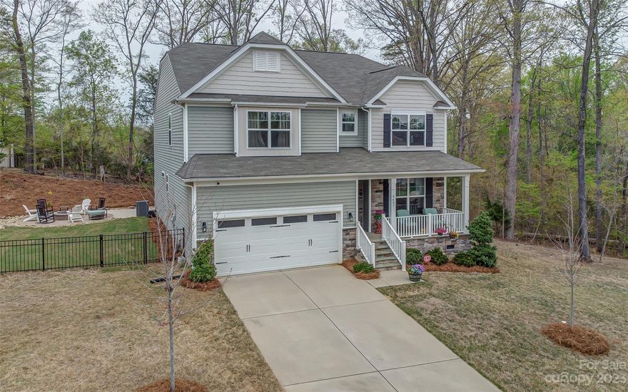 Calling for Highest and Best by 8pm on April 4! Come enjoy the seasonal views of Lake Wylie in this beautiful Davidson floor plan. This five bedroom, three bathroom home features a guest suite on the main floor. You’ll also enjoy a home office, dining room and open kitchen floor plan which opens to your living room. Upstairs you will find the primary bedroom, three additional secondary bedrooms and an open loft.  Enjoy the outdoor space: step out onto the covered porch or sit by the paver fire pit in your fenced in wooded backyard-perfect for entertaining. This home is close to all that Lake Wylie, Belmont, Clover, York, Rock Hill and South Charlotte have to offer.