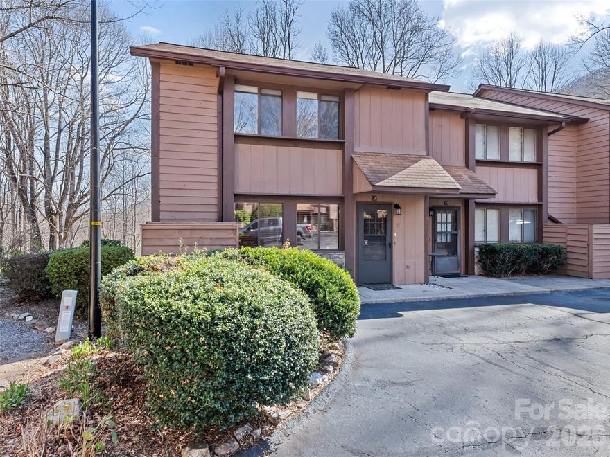 Nestled in the heart of Maggie Valley, this exceptional end-unit townhome offers a bright and airy mountain escape that is perfect for year-round living or a second home.The main level is anchored by a beautiful rock wood-burning fireplace, creating an inviting space for cozy evenings. This level also features a kitchen with freshly refinished cabinets and tile countertops, opening to a dining area and a living room with a unique picture window—the only one of its kind in the neighborhood. A convenient half-bath and a large walk-in storage closet complete the first floor.The upper level serves as a private sanctuary, housing a primary bedroom with a full bath and two comfortable guest bedrooms served by a second full bath. The primary ensuite is a true highlight, opening onto a balcony where you can take in panoramic mountain views during the fall and winter and enjoy the comfort of being hugged by nature in the spring and summer months. Located as an end unit, the home provides easy access to the spacious level commons area, offering a quiet sanctuary to enjoy the fresh air and mature landscaping. This impeccably kept townhome is a rare find that perfectly captures the tranquility of Maggie Valley, with the added peace of mind that no rentals are allowed in the community. Update: Step into a home that feels brand new. The main level has been meticulously refreshed with stunning, high-durability luxury vinyl plank flooring throughout. This upgrade follows a professional remediation of a localized plumbing leak, offering the perfect blend of modern aesthetics and total peace of mind for the new owner.