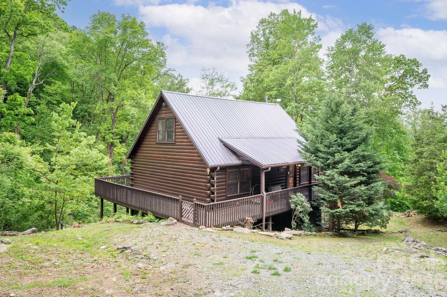 Tucked among whispering trees and rolling mountain views, this charming 2-bedroom (2 bedroom septic), 2-bath cabin offers the kind of peace and privacy that’s hard to find—and even harder to leave. The loft is currently being used as a 3rd bedroom with it's own private full bathroom. Nestled on 18 serene acres (with the option to add 8 more for a total of 26 private, picturesque acres—MLS 4266196), this property is more than just a home; it’s a retreat for the senses. A cheerful stream winds its way through the landscape, catching sunlight as it flows, while birdsong fills the air and a gentle breeze moves through the trees. Whether you’re looking to build, expand, or simply rest, this land welcomes imagination and possibility, with multiple potential homesites ready for your vision. Step inside and you’ll find a bright, open living space filled with warmth and natural light. Vaulted ceilings create a sense of airiness, while the open-concept design invites connection and comfort. The main-level bedroom offers easy convenience, while upstairs you’ll discover another spacious bedroom, a full bath, and a flexible bonus room—ideal for guests, a creative studio, or a quiet home office with views that inspire. The full, unfinished basement—complete with garage access—adds even more potential. It’s a blank canvas for storage, a workshop, or future finished living space. Thoughtful details throughout the home, like two high-end hypoallergenic air purifiers (one LED and one electric), enhance the feeling of freshness and care that defines this mountain hideaway. Step outside, and it’s easy to see why this setting feels so special. The land unfolds in gentle layers of forest and meadow, offering beauty in every season—from the first blooms of spring to the gold and crimson hues of autumn. The cabin sits along a quiet street with only a few neighbors nearby, creating a sense of true seclusion without leaving you isolated. Here, you can spend mornings by the stream, afternoons exploring the trails that weave through your property, and evenings watching the stars rise over the ridgelines. Whether you’re dreaming of a weekend getaway, a peaceful homestead, or a forever home tucked deep in nature’s embrace, this property offers a rare chance to live in harmony with the mountains—while having the space, beauty, and flexibility to grow. This isn’t just a cabin—it’s an invitation to slow down, breathe deeply, and come home to the mountains.