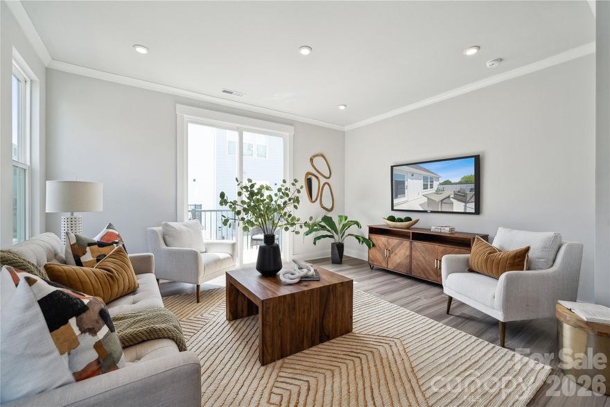 A premium lot with great views. Evenings on your rooftop terrace are sure to impress. The massive, rear load, 2 car tandem garage opens up to a unique feature of this particular home. Inside, your kitchen is designed with beautiful quartz countertops, polished chrome hardware, and luxury vinyl plank flooring throughout. Upstairs, each of the 3 bedrooms has it's own en-suite full bath making this home perfect for roommate or multi-generational living. Iron Creek is a brand new, luxury townhome community conveniently located in North End Charlotte. Just minutes from Optimist Hall, less than a mile from the AvidXchange music factory, and only 2 miles from BOA Stadium. Stop by, take a tour of our model or call and ask about our UTour option.