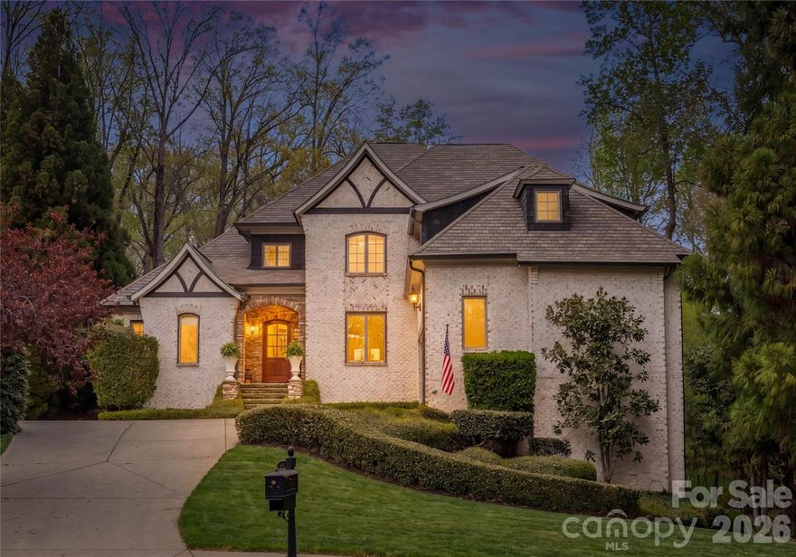 Welcome Home to your own private retreat, tucked into a serene wooded cul-de-sac setting just minutes from the conveniences of Matthews and Charlotte. This custom all-brick residence offers six bedrooms and exceptional living space designed for both everyday comfort and effortless entertaining. Set on a premium lot with abundant open space for recreation, the home blends timeless architecture with a peaceful natural backdrop.
Inside, dramatic design elements make an immediate impression, including a 30-foot cedar-paneled ceiling, a dramatic tapered river stone fireplace with solid timber mantel, and a stunning two-story wall of windows that bring the outdoors into the heart of the home. 
In 2026, the main level was enhanced with curated designer lighting, while the chef’s kitchen was beautifully remodeled with an expansive island and handmade Moroccan Zellige tile.  The kitchen flows seamlessly into the breakfast area, keeping room and screened in porch, creating an inviting space for gathering. Main floor living areas with 10' ceilings connect beautifully for entertaining while offering elevated views of the expansive backyard. The main-level primary suite provides convenience and privacy, while the second floor features three spacious bedrooms, each with its own ensuite bath and a bonus room. 
The ground floor is unmatched with 10’ ceilings and includes media and entertainment area with speakers, dedicated fitness space, kitchenette, office/bedroom, guest bedroom/bath, plus an additional flex room ideal for a den, wine room, or music room. The ground level also functions perfectly as a guest suite or private living quarters for an au pair or extended stay visitors.
Additional features include: extensive hardwood flooring, Italian porcelain tile, solid-core doors, and upgraded millwork reflecting the quality found throughout. Two laundry rooms, three fireplaces, built in speakers and generous walk in storage add comfort and function throughout the home.
Conveniently located to private and public schools, restaurants, retail, shopping and Uptown Charlotte.
Homes like this are rare, with its peaceful setting and expansive layout, this home truly feels like a vacation every day.