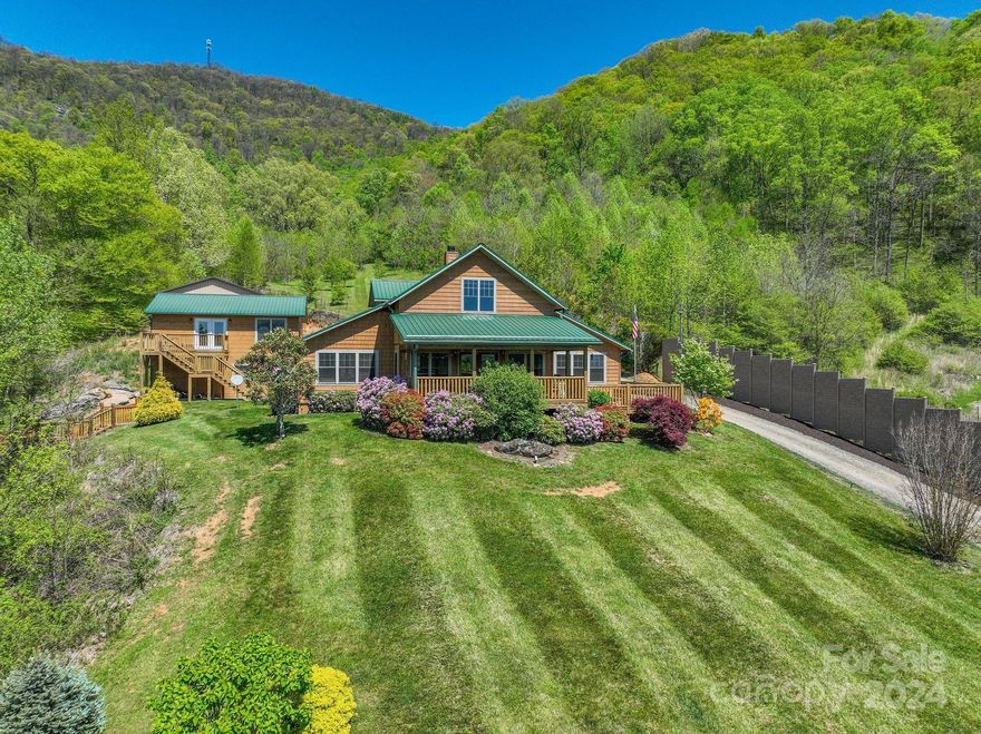 Nestled amongst the mountains of Haywood County this sprawling estate offers unrivaled privacy and tranquility. From the moment you arrive, you'll be captivated by the close & long-range mountain views throughout the property. Featuring a main cabin, guest home & apartment - all offered furnished. At the primary home you'll find a modern cabin with floor-to-ceiling stone fireplace, 2 Primary Suites on Main, an expansive & partially covered deck with hot tub & plenty of room for entertaining & unrivaled sunsets! Detached is a matching garage with a 2 bed apartment above. At the property entrance, discover the 2 bed guest cottage with a nice outdoor area, timeless barn and 2nd hot tub. Beyond the main home, a spacious 1904 sq. ft. garage/utility bldg that provides the perfect space for your ATVs when you're not exploring the meandering creek and manicured trails that wind throughout the property. Prior Vacation Rental history. Property video here: https://vimeo.com/944450830?share=copy