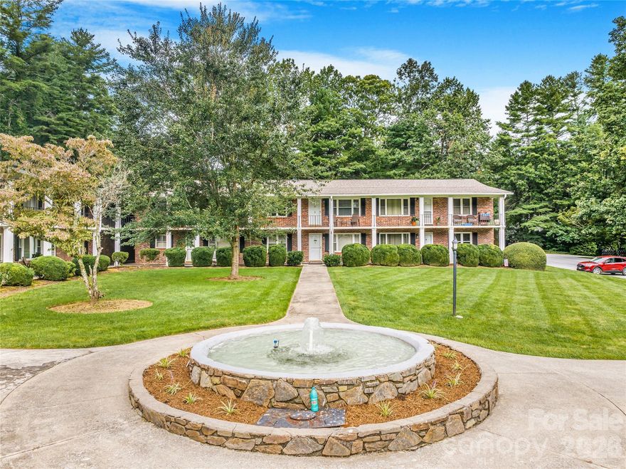 Discover this spacious, light-filled 2-bedroom, 2-bath condo located in a charming brick complex in the tree-lined community of Flat Rock, NC. Just minutes from the Flat Rock Playhouse, local theater, bakery, BBQ, and the Carl Sandburg Historic Site, this second-floor unit offers a peaceful setting with views of a beautifully landscaped courtyard and central fountain.  Enjoy access to a clubhouse for private gatherings, abundant guest parking, and covered parking near your unit. An 8’x8’ private storage space is included, along with free onsite laundry facilities. Inside, you'll find a generously sized primary bath, abundant closet space, and plenty of kitchen cabinetry.  This well-maintained, quiet community offers comfort, convenience, and a relaxed lifestyle in a highly desirable location.