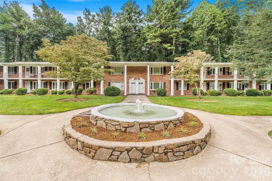 Discover this spacious, light-filled 2-bedroom, 2-bath condo located in a charming brick complex in the tree-lined community of Flat Rock, NC. Just minutes from the Flat Rock Playhouse, local theater, bakery, BBQ, and the Carl Sandburg Historic Site, this second-floor unit offers a peaceful setting with views of a beautifully landscaped courtyard and central fountain.  Enjoy access to a clubhouse for private gatherings, abundant guest parking, and covered parking near your unit. An 8’x8’ private storage space is included, along with free onsite laundry facilities. Inside, you'll find a generously sized primary bath, abundant closet space, and plenty of kitchen cabinetry.  This well-maintained, quiet community offers comfort, convenience, and a relaxed lifestyle in a highly desirable location.