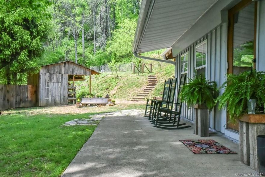 Artists Haven & Homesteaders Heaven! Uniquely artistic 3/2 has been incredibly transformed through use of concrete counters, wood beams, River rock wall & wood-burning stove, wood walls, copper accents; slate, hand-scraped wood laminate, and hardwood flooring. 2.85 surveyed acres zoned R-A, selectively fenced for goats. Enclosed shop, covered wood pile, lg. covered utility shed w/work area & storage, additional shed. Serene rural setting yet 3 miles to town, schools, & I-26. See attached video!