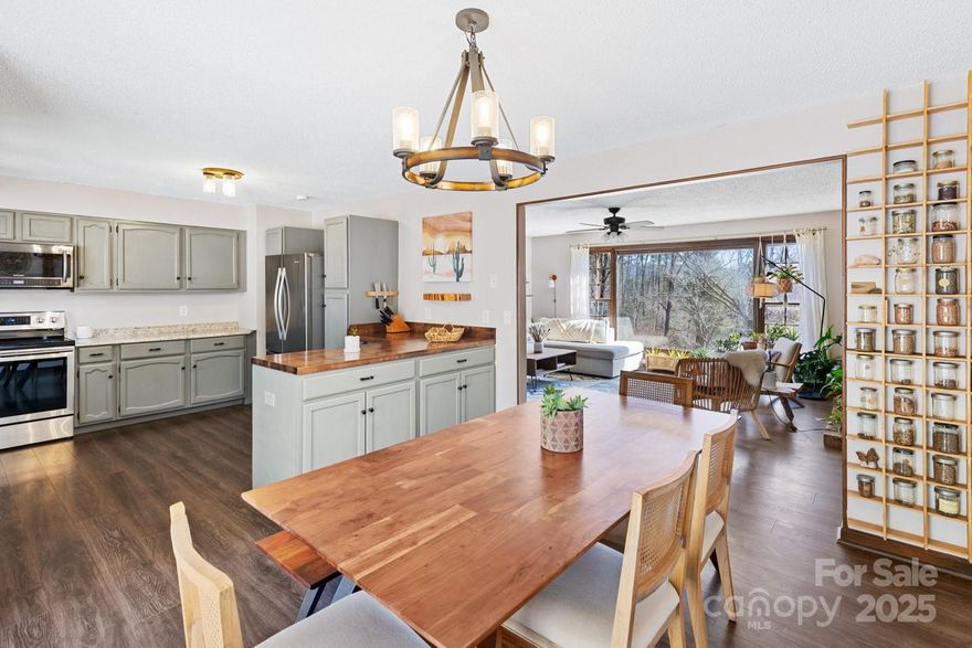 Charming Fairview Retreat – just 10 Minutes from Asheville! Discover the perfect blend of country charm and modern convenience in this beautifully updated home, nestled on nearly 2 unrestricted acres. Enjoy the serenity of lush, level land while being just a short drive from downtown Asheville. Step inside to an inviting open floor plan filled with natural light, featuring a cozy stone fireplace, a spacious kitchen, and a dining area that seamlessly extends to the rear deck—perfect for entertaining or simply relaxing in the peaceful surroundings. With 3 bedrooms and 2.5 baths, this home offers ample space, plus a versatile lower level ideal for a additional guest suite(s), home office or flex space(s) to suit your needs. Outside, a spring-fed creek and a level yard provide endless possibilities for gardening, recreation, or even future expansion / homesite opportunity. Embrace the best of both worlds — a tranquil countryside setting just minutes from everything the area has to offer.