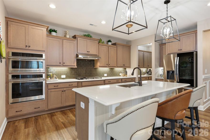 Welcome to this stunning 3 bedroom/3 bath ranch home located in the highly desirable Overlake community of Belmont. Designed for modern living, this open-concept residence features soaring 9.5-foot ceilings and no carpet throughout, creating a light-filled, contemporary feel from the moment you enter. The chef-inspired kitchen serves as the centerpiece of the home, showcasing quartz countertops, soft-close cabinetry, stainless steel appliances and an oversized island perfect for meal prep and hosting. The kitchen flows effortlessly into the sun-drenched living room with dramatic cathedral ceilings, while a dedicated dining room provides an ideal setting for hosting family and friends. Out back, you'll find a covered patio as well as an additional patio for true outdoor living as well as a new fenced in yard. The main-level primary suite is a true retreat, highlighted by tray ceilings, a spa-like en-suite bath with a spacious dual sink vanity and a large stand-alone tiled shower, and a custom walk-in closet with built-ins for exceptional storage. An additional main-level bedroom and a stylish full bath offer flexibility for guests. Upstairs, a generous loft provides versatile flex space, accompanied by an additional bedroom and full bath — ideal for guests, a private work-from-home setup or a secondary living area. Residents of the Overlake community enjoy access to outstanding amenities, including a pool, playground and scenic walking trails. Conveniently located just 15 minutes from downtown Belmont and 25 minutes from Charlotte Douglas International Airport, this home offers the perfect blend of comfort, style and location!