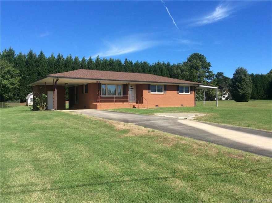 Well-maintained brick ranch, currently on well and septic but tap fee was paid for city water/city sewer, level corner lot, convenient location close to medical area, shopping & dining, updated gutters, downspouts, windows, roof in 2011, beautiful knotty pine cabinets and paneling in dining room, hardwood floors, large rooms, move-in ready, attached single & detached single carport