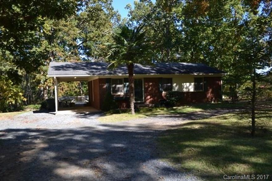 This is an AS IS SALE.  Cute ranch with attached single carport and HUGE deck.  3 bedrooms, 2 baths and large laundry room.  Spacious kitchen with unique breakfast bar and plenty of cabinets.  Master bedroom is massive and has a door leading to the deck.