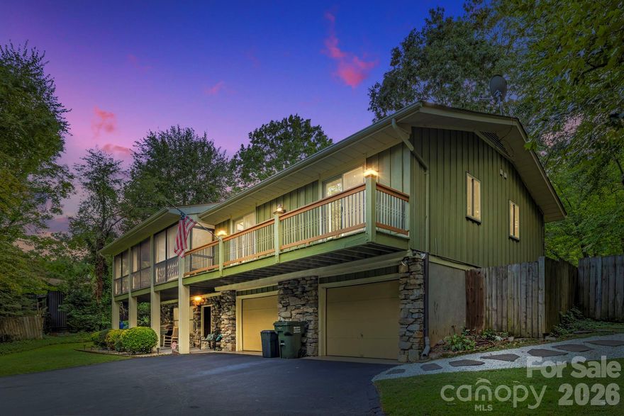 This beautifully maintained mountain residence offers an inviting blend of comfort, style, and thoughtful design. From the moment you arrive, the setting feels welcoming, lush peonies and hydrangeas in bloom, a graceful front curb line framed by seasonal flowers and mature azaleas, creating a vibrant display each spring. On the main level, vaulted ceilings enhance the spacious great room, where a second gas fireplace creates a warm and welcoming focal point. The kitchen is thoughtfully equipped for the home chef, featuring granite countertops, stainless steel appliances, a gas range, generous pantry storage and a sunny eat-in dining area. A formal dining room offers a setting for gatherings large and small. The primary suite provides a peaceful retreat with walk-in and reach-in closets and an en-suite bath, while two additional bedrooms and a full hall bath complete the upper level. The lower level is designed for everyday living and flexibility. A cozy family den anchored by a rustic stone gas fireplace sets the tone for relaxed evenings, while a well-appointed designer laundry room adds convenience with style. A versatile bonus room with a deep closet and adjacent full bath provides excellent space for guests, a home office or creative pursuits. The expansive 826-square-foot garage, complete with custom shelving and a durable epoxy floor, offers exceptional room for storage, hobbies or projects. Outdoors, the fully privacy-fenced backyard showcases mature landscaping, including flowering magnolia, forsythia, crape myrtle and azalea, surrounding an epoxy-coated patio ideal for relaxing or entertaining. The covered, screened front porch invites quiet mornings with coffee or easy evenings spent unwinding. Just 10 minutes from historic downtown Hendersonville and less than 20 minutes to South Asheville, this home offers the ideal balance of mountain charm and everyday convenience.