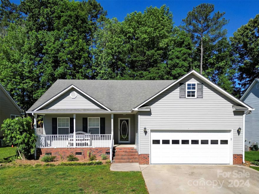This updated ranch is in a perfect location! Literally a 3 minute stroll to Ebenezer Park, beach, and access to Lake Wylie! Open concept living and a split bedroom plan accommodate family and guests. New flooring throughout, new fixtures and neutral paint give the home a light and bright aire. The primary suite features a tray ceiling, double sinks, updated backsplash and a lg. walk-in closet. Secondary bedrooms also have new flooring, fresh paint and walk-in closets. Enjoy the front porch & back yard, where you can relax on the composite deck with benches, a large travertine patio and a fire pit.  There are many fruit trees and bushes, as well as a small wooded area at the back of the property. The attached 2 car garage allows ample storage options. New HVAC 2020. Gas heat and hot water heater. HOA $180/year. This home is USDA eligible and will qualify for other Home Grants up to $17,500. Contact listing agent for more information. Tree swing and rain barrels will not convey.