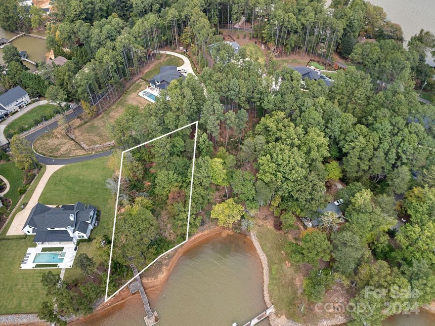 Your Lake Norman dream home awaits! Nestled in a peaceful cove on the Brawley Peninsula this leveled waterfront lot offers a great opportunity to build your Lake Norman dream home on .77 acres. Dreaming big? Combine this lot with the available adjacent lot .77 acre lot at 155 Binns Road for over 1.47 acres! This is a rare offering to own a single or double waterfront lot on the Brawley Peninsula! 167 Binns Road is located just beyond The Point is one of Lake Norman's most desired areas offering incredible lake living on a beautiful, private street with no HOA. Trump National Golf Club Charlotte is minutes away offering the best of golf, tennis, dining, pool & community events.