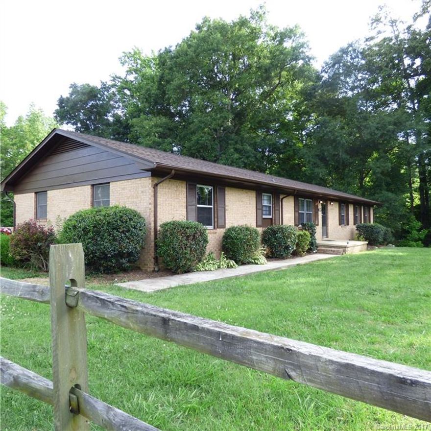 HOME AGAIN! Memories of the peace and tranquility of a slower life become reality once again in this warm and inviting country home. Large country kitchen/great room with a mountain of cabinetry and a brick fireplace.4 large bedrooms (including a very ample master suite). Carpet, vinyl ,wood laminate and hardwood floors.  Basement has wood heater and 1/2 bath.There is a large detached garage/workshop with a wood heater. 2.15 Acres of Peace and Quiet! The horseshoes and pins are already in place!