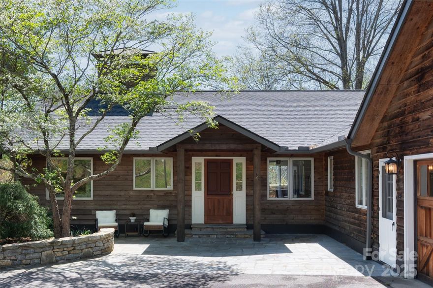 Take a deep breath and feel yourself unwind as you step into this incredible home in the Beaverdam area of N. Asheville. On almost 4 acres with fantastic long range mountain views, this property is an entertainer's delight! Feel the mid-century vibes while enjoying the open chef's kitchen which flows effortlessly into the spacious living and dining areas. Wood details, beautiful beams and a floor to ceiling stone fireplace, make this home both cozy and comfortable. Plus you’ll love overlooking your large pastureland and the mountains as you relax in the light-filled sunroom or on the large back deck! The unique primary suite includes a private screened porch and a huge walk-in shower, plus there are multiple smaller bedrooms for offices, dens, craft rooms or more. The flexible lower level has a 2nd kitchen and full bath making it a great guest suite or maybe it’s your new game room, family room, home gym or all three…endless possibilities await! Come see this lovely property today!