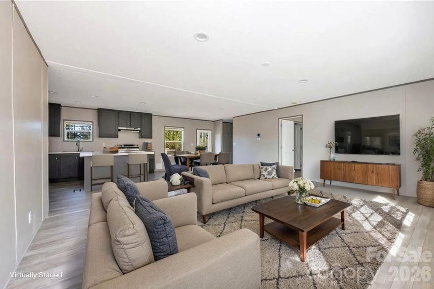 BRAND NEW 2026 three bedroom, two bathroom Clayton home offers 1,500 HSF and is situated on a cleared, level lot in the quiet countryside off Hwy 18 in Connelly Springs. Features include charming post and beam covered front porch, brick skirting, low maintenance vinyl siding, and a wall of mature trees in the backyard for privacy! Inside, the open floor plan offers LVP flooring, living room opening into the kitchen, which features all appliances, center island, stainless appliances and adjoining dining area. The split bedroom layout offers two bedrooms sharing a full bath on one end, a bonus room/office, and a private primary suite with huge walk-in closet and full bath on the opposite end of the house. Large utility/mud/laundry room. Seller offering $3,000 closing costs assistance with acceptable offer.