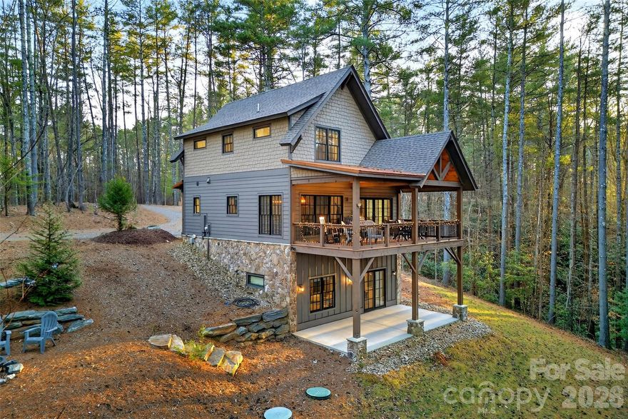 Welcome to 103 Big Game Drive, nestled in the highly sought-after Old Wildlife Club at Lake James. This 4-bedroom, 3-bath home may look modest from the outside, but it truly lives big, offering a thoughtfully designed layout that maximizes space, comfort, and functionality.

The home features two spacious living rooms and two fireplaces, creating inviting spaces for relaxing or entertaining on multiple levels. The downstairs living area is ideal as a game room or secondary entertaining space, complete with a sink, mini fridge, and granite-topped cabinetry—perfect for hosting guests or cozy movie nights.

Step outside to enjoy the large covered back porch, an ideal spot for morning coffee, evening gatherings, or simply taking in the peaceful surroundings.

Ownership includes access to the exceptional Camp Lake James amenities, featuring pickleball and tennis courts, a resort-style pool, hot tub, fitness facility, and on-site restaurant, all just minutes away. Best of all, a deeded boat slip is included, offering effortless access to Lake James for boating, swimming, and lakeside adventures.

Whether you’re seeking a full-time residence or a mountain retreat, this home delivers the perfect blend of comfort, versatility, and Lake James lifestyle in one of the area’s premier communities.