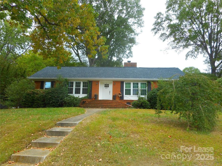 This beautifully maintained all brick ranch home is located in the highly desirable neighborhood of College Downs, within walking distance of UNC Charlotte. Sweet hardwood flooring thru out home. Marvelous counter tops and upgraded fixtures. This 3 bedroom, 2 bath home sits on a lovely landscaped corner lot with a concrete walkway that leads to a grand staircase at the front door. Upon entry you are greeted by a welcoming foyer that overlooks a spacious living and large dining room which are flooded with natural light. The dining room leads into a large kitchen with double ovens and plenty of cabinet and counter space. The great room features a quaint brick wood burning fireplace. Primary suite includes two closets and primary bath. Two spacious secondary bedrooms share a second full bath. Flat backyard with patio and shed! Washer, dryer included.