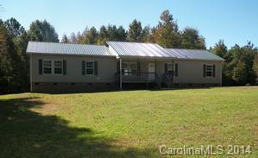 Don't miss this spacious modular with a split floor plan, located on 1+ acre. It features a concrete driveway, front covered porch, modern metal roof, rear decks and plenty of room to roam.  The front porch leads into the LR with adjacent kitchen (new appliances) and adjoining DR, leading to the den.  The MB suite allows for plenty of privacy and features a soaking tub with separate shower. With the freshly painted walls and new carpet in most of the living space, you can move right in.