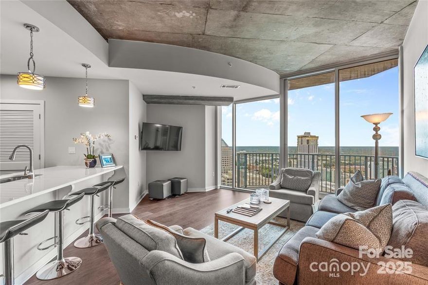 Enjoy a comfortable and contemporary lifestyle in this updated 1 bedroom, 1 bathroom condo located in the Heart of Uptown. This most appealing unit has 850 sq ft and Stunning (especially night time) views of the city & skyline from the 26th floor with floor to ceiling windows. With the well planned entertainment & living space, this unit lives large!  Updated kitchen with all new appliances (included) and spacious living room and bedroom with ample storage.  Convenient laundry closet with washer and dryer included. Enjoy the convenience of a deeded parking spot in secure, gated residents only garage. Amenities include pool, fitness center, onsite office/workroom, clubhouse, billiards and several outside seating/grilling areas with TVs as well as a huge roof top pool. 24-hour concierge. HOA covers google fiber internet. This prime location is walking distance of Spectrum Center, Belk Theatre, Monarch Market Food Hall, Bank of America stadium, Truist Park, Harris Teeter and so much more!